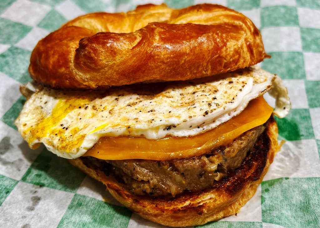 Goetta, egg and cheese sandwich on a croissant.