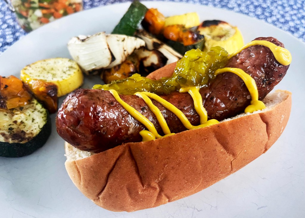Grilled BOR Meats Vidalia sausage link topped with mustard and relish.